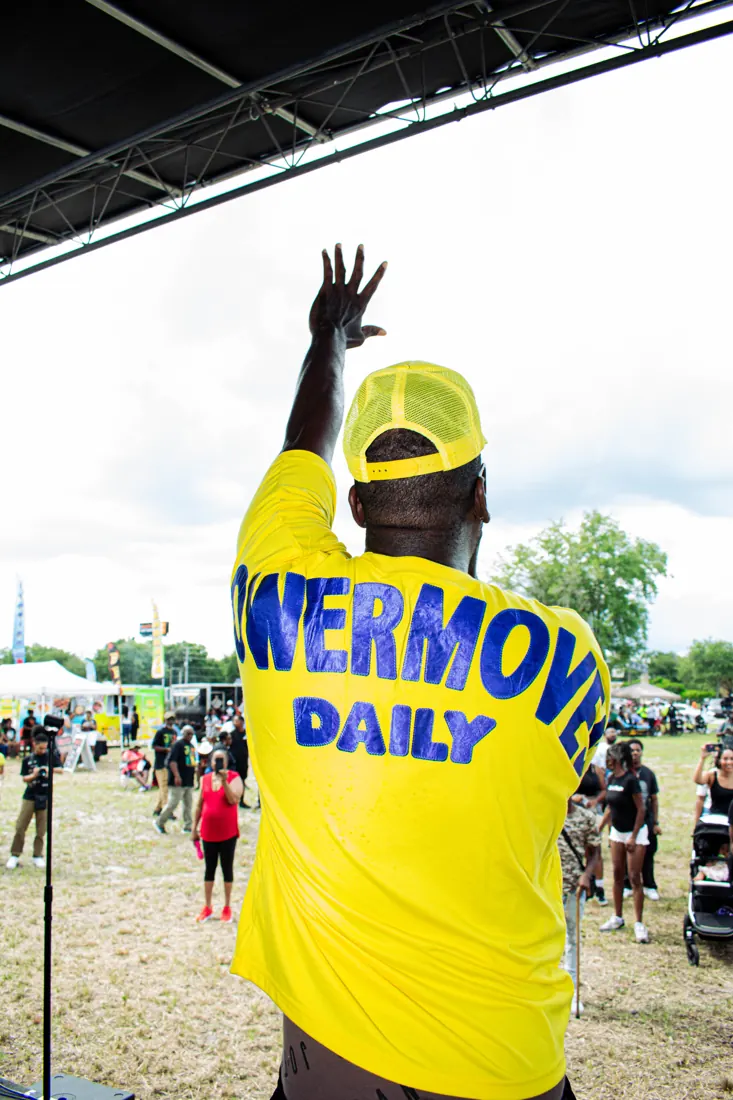 A community member raising a hand at an Eatonville gathering